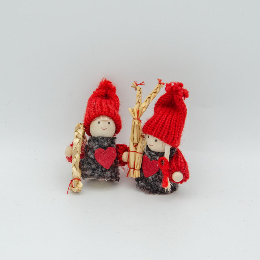 Tomte boy and girl carrying straw decorations